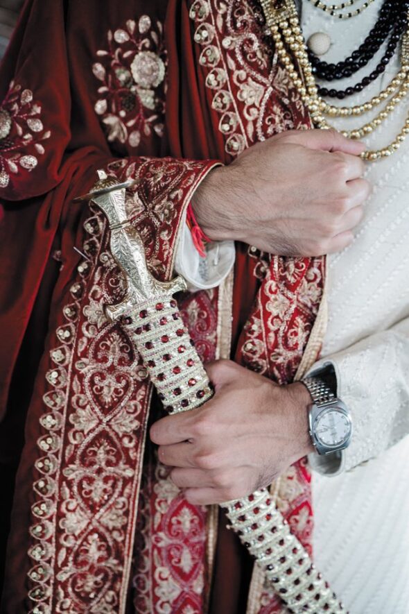 Sworn to Protect: Hindu tradition dictates that the groom carry a sword to symbolize his promise to protect his bride from harm. This prop sword and Manish’s traditional wedding attire were purchased from Kora in the Indian city Ahmedabad. The Citizen watch belonged to Manish’s grandfather, purchased when hefirst arrived in the U.S.in the 1980s.