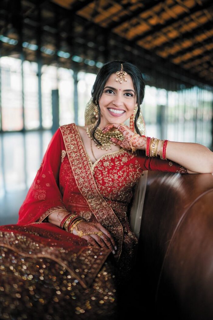 Blushing Bride: Gargee wore a traditional Indian wedding gown custom made by Kamakshi Designer Studio in the city of Ahmedabad, in western India. Her bangles were a gift from her parents, and her necklace and earrings were from her uncle. “Each piece was given to me by close family,” she says.